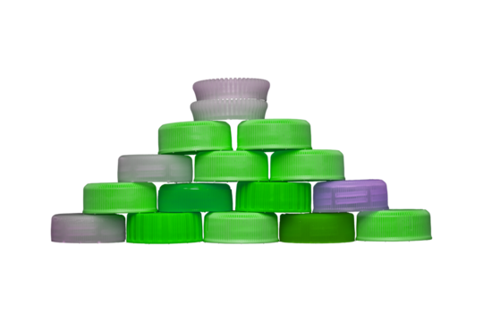 Green plastic HDPE caps pyramide from drinking water bottles isolated on a transparent background.