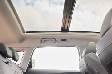Motor vehicle with sunroof, rear view mirror, and hood