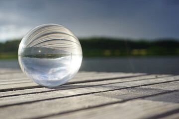 glass ball on a wooden pier 