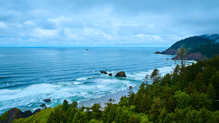 Aerial View of Rugged Pacific Northwest Coastline with Forested Cliffs