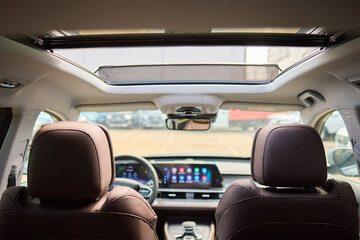 Motor vehicle with sunroof, rear view mirror, and hood