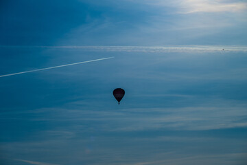 Hot air balloon rising on a sunny evening.