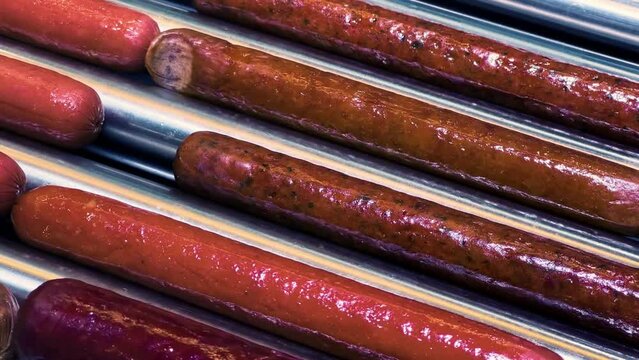 Sizzling Sausage Variety on Gas Station Roller Grill | Hot Dogs, Bratwurst, Frankfurters Cooking | Convenient Snack for Hungry Travelers | Quick Grab-and-Go Food Display