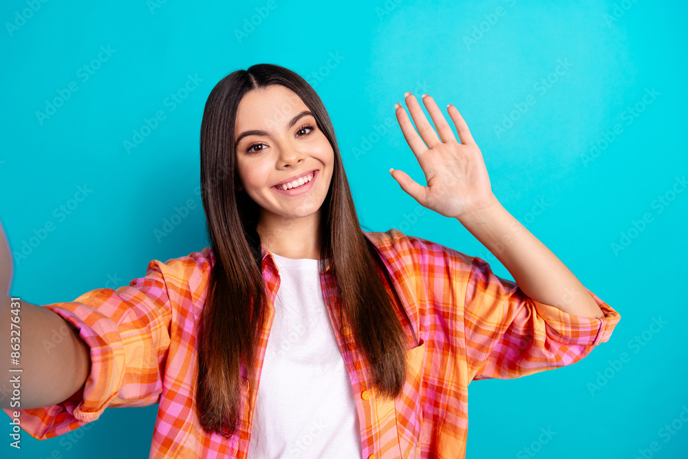 Poster portrait of nice girl make selfie arm wave wear checkered shirt isolated on turquoise color backgrou