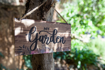Fototapeta premium Garden welcome sign with mediterranean courtyard as background