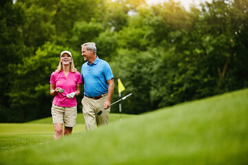 Mature, couple and walk on golf course, outside and healthy fitness activity with golfers together...
