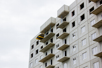 Construction of an apartment panel building. Construction of concrete house, real estate.