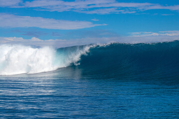 Monster waves at Teahupoo, Tahiti, French Polynesia - a world famous spot for surfing championships. The village of Teahupoo is known as “The end of the road” because the road from Papeete ends there.