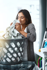 Woman, laundry scent and basket for clean towel in home, hygiene and fresh linen aroma. Female...
