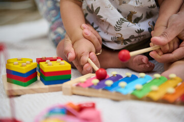 Parent and child playing with colorful educational toys