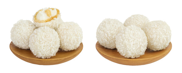 round candy raffaello with coconut flakes and nut in wooden bowl isolated on white background