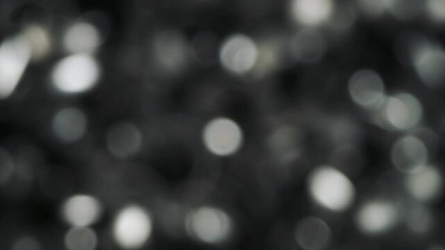 aluminum particles falling away from the camera silver shine bokeh 