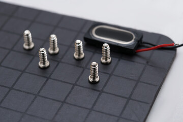 Mobile phone components on a magnetic pad, close-up