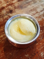 The Indian dessert - Rasmalai on a wooden table.