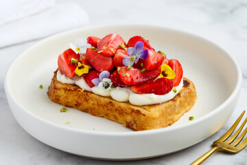 Strawberry brioche toast with cream on a plate. Gourmet breakfast. Selective focus