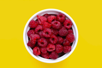 Fresh raspberry on yellow background.