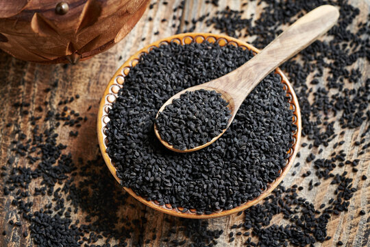 Black cumin or Nigella sativa seeds in a bowl and on a spoon