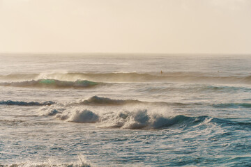 A slightly outoffocus image of waves breaking on a sandy shore