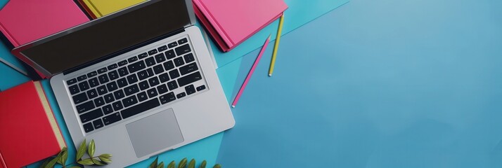 A laptop computer, textbooks, and pencils lay on a blue desk, representing modern methods of learning. Generative AI