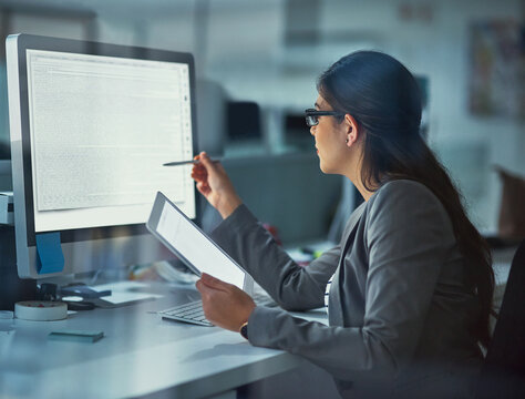 Computer screen, night and web development with woman at desk in office for coding or programming. Information, software and tech with business person in workplace for project management on tablet