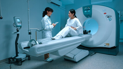 Patient woman in white clothes complaint at muscle chest pain to radiologist doctor while sitting...
