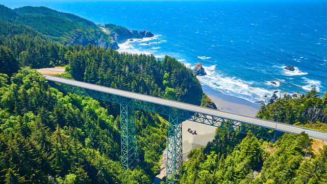Aerial View of Teal Thomas Creek Bridge Over Lush Forest and Coastline