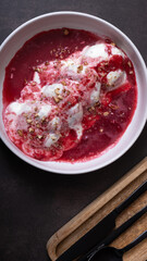 Plate of cottage cheese fritters in cream-cherry sauce top view, flat lay