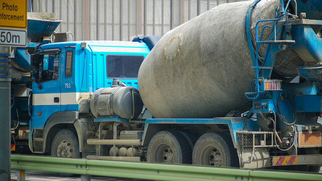 Ready-mixed concrete truck parked at a road construction site