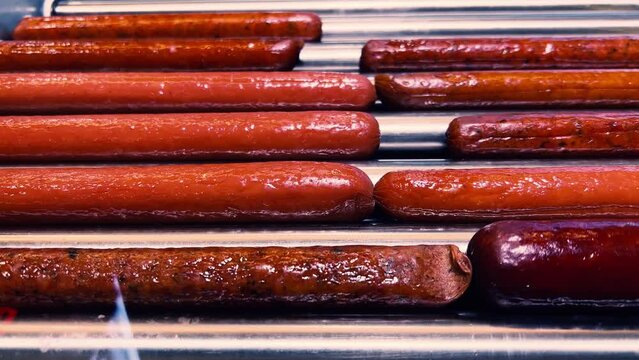 Rotating Roller Grill Magic: Gourmet Sausages at Fuel Stop | Bratwurst, Frankfurters, Wieners Sizzle | Roadside Culinary Delight | Quick-Serve Comfort Food
