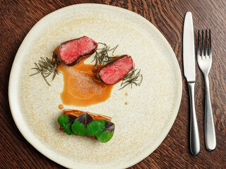 Medium-Rare Steak with Potato Gratin and Herb Garnish on Plated Dish..