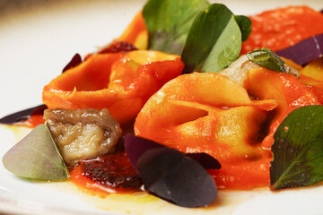 Elegant Pasta Dish with Tomato Sauce and Herbs on Gold-Rimmed Plate..