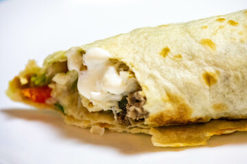 Traditional Shawarma sandwich fresh roll of, Grilled Meat and salad tortilla wrap with white sauce isolated on white background. Details