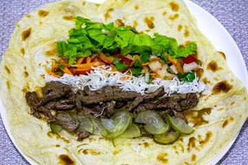 Traditional Shawarma sandwich fresh roll of, Grilled Meat and salad tortilla wrap with white sauce isolated on white background. Details