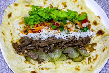 Traditional Shawarma sandwich fresh roll of, Grilled Meat and salad tortilla wrap with white sauce isolated on white background. Details