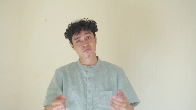 Moslem Asian man video call gesture when Ramadan celebration. The footage is suitable to use for business Ramadhan poster and Muslim content media.