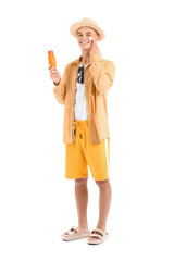 Happy young man with sunscreen cream on his face against white background