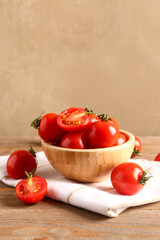 Bowl with fresh cherry tomatoes on wooden table
