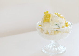Corn ice cream in glass bowl on a table.
