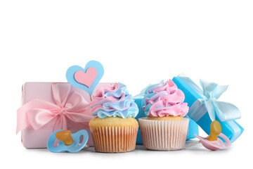 Delicious cupcakes with gift boxes and pacifiers on white background. Gender reveal party concept
