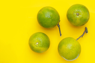 Citrus sinensis, sweet orange fruit on yellow background