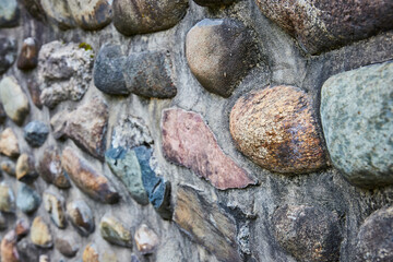 Varied Stone Wall Close-Up with Rust-Colored Boulder