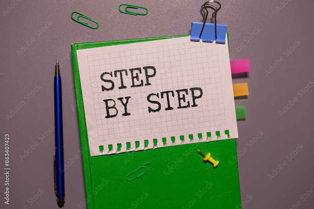 Poster concept step by step text written on wooden blocks on a dark background.