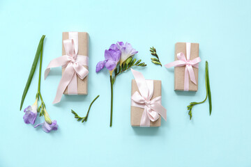 Beauty wrapped gift boxes decorated with natural flowers on cyan background