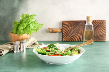 Bowl of fresh vegetable salad with radish green table