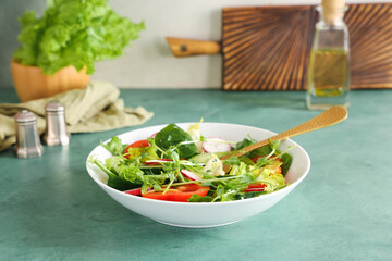 Bowl of fresh vegetable salad with radish green table