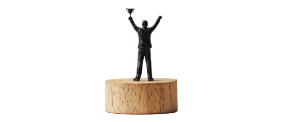 A miniature bronze sculpture of a man raising his arms in victory on a wooden base.