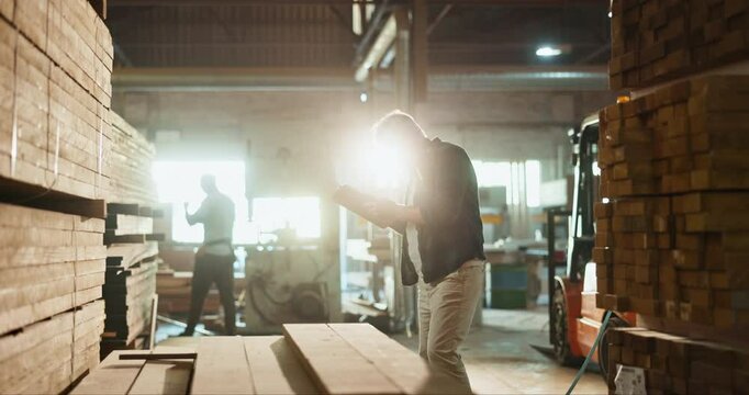 Industrial, warehouse and wood inspection for manufacturing, logistics and shipping in supply chain. Man with clipboard, checklist or paperwork for timber, carpentry material and stock or inventory