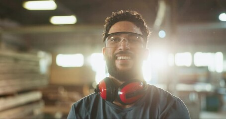 Man, carpenter and face in workshop or factory for wood production, manufacturing and trade in safety gear. Young industry worker with smile, confidence and portrait for artisan career in warehouse - Powered by Adobe