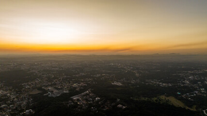 Curitiba in Paraná, Brazil. Aerial View. Wonderful sunset with views of buildings and Tanguá Park. Lake with reflection..