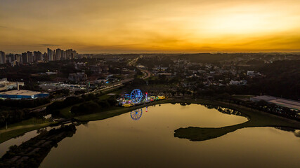 Curitiba in Paraná, Brazil. Aerial View. Wonderful sunset with views of buildings and Tanguá Park. Lake with reflection..